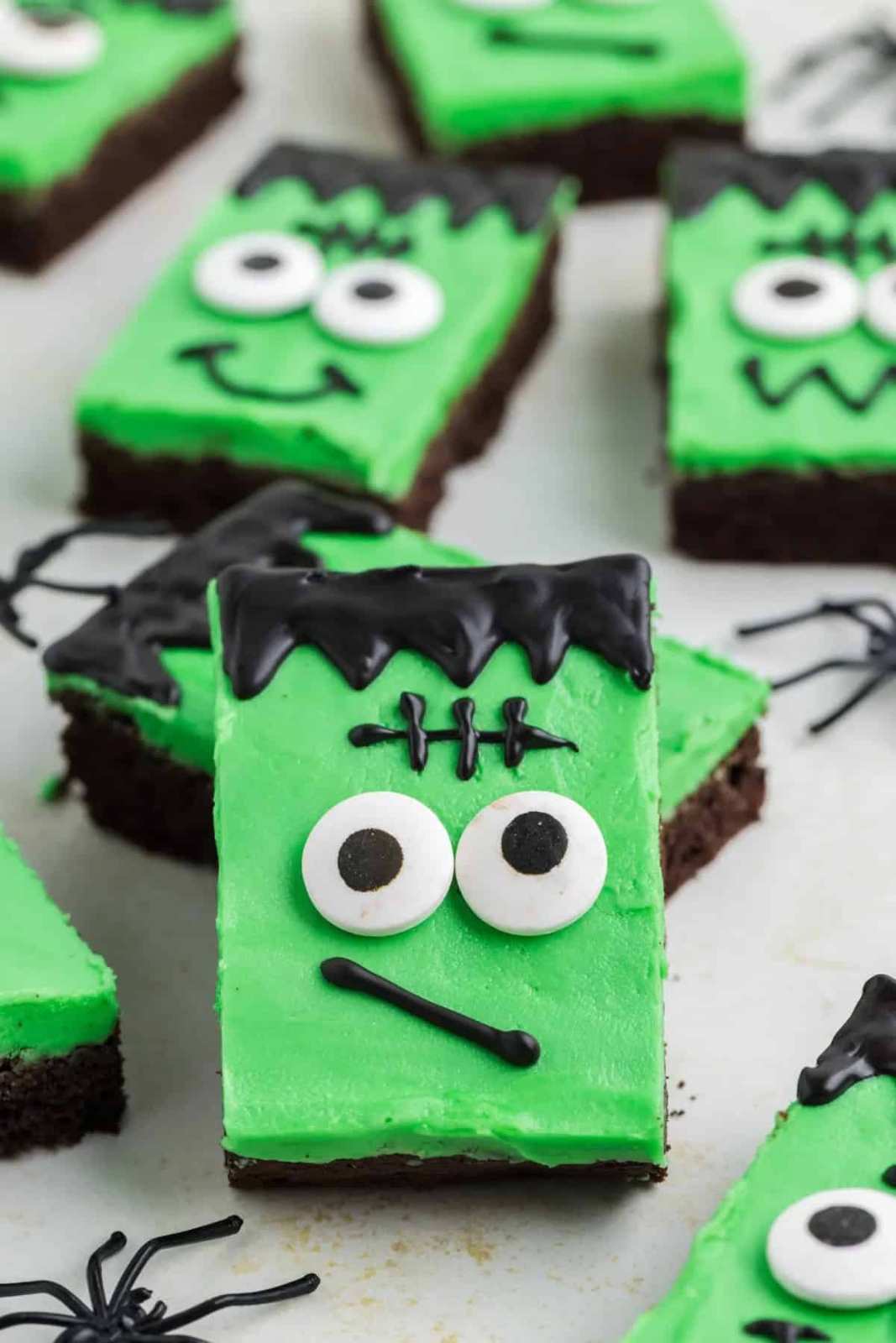 Green frosted cookie bars with chocolate eyes and bolt-shaped candy decorations